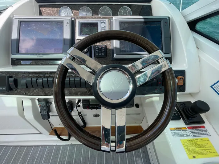  Yacht Photos Pics Steering wheel and dashboard of 2010 Sea Ray 450 Sundancer yacht with navigation screens.