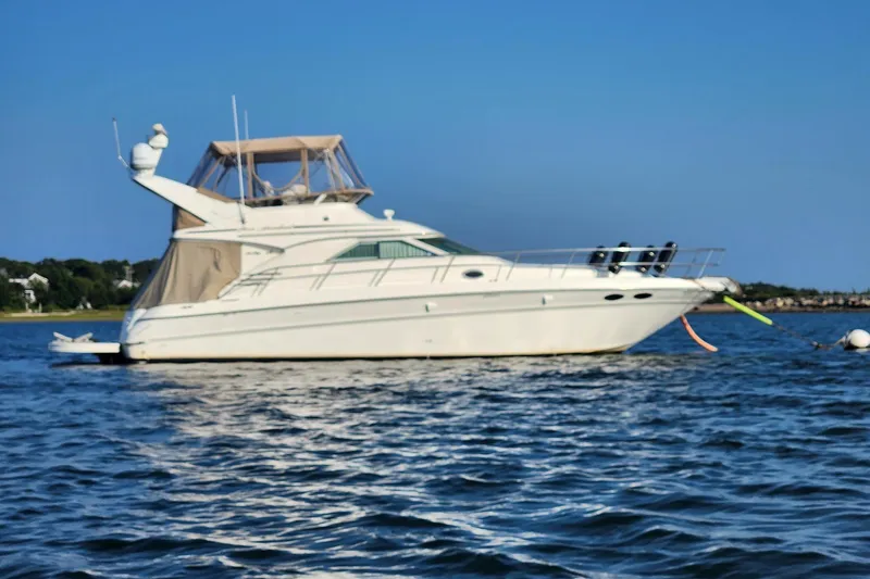 Four Seas Yacht Photos Pics 2001 Sea Ray 400 Sedan Bridge yacht anchored on calm water.