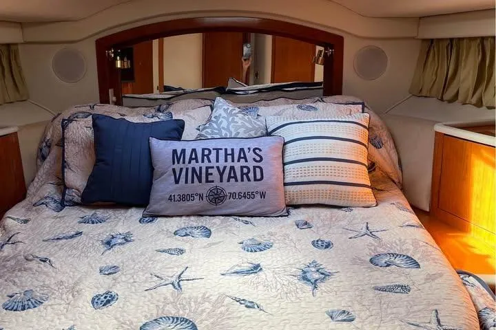 Four Seas Yacht Photos Pics Luxurious 2001 Sea Ray 400 Sedan Bridge cabin with nautical-themed bedding.