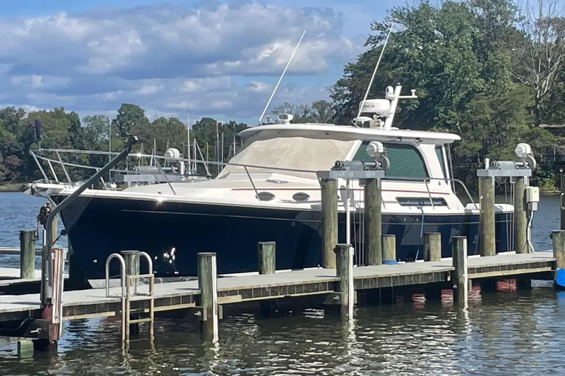 Selah Yacht Photos Pics 2012 Back Cove 37 yacht docked on a serene lake with lush greenery.