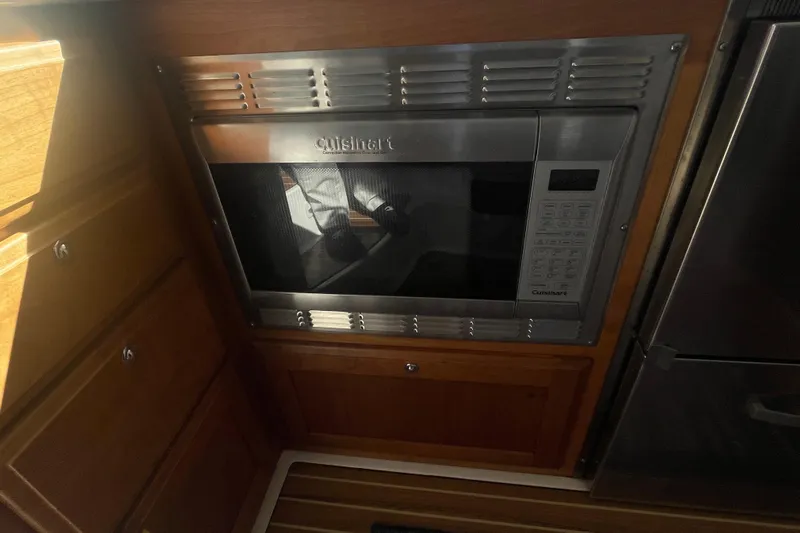 Selah Yacht Photos Pics Cuisinart microwave in 2012 Back Cove 37 yacht kitchen, wooden cabinetry.