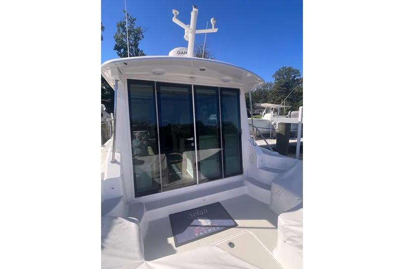 Selah Yacht Photos Pics 2012 Back Cove 37 yacht with glass doors and outdoor seating area.