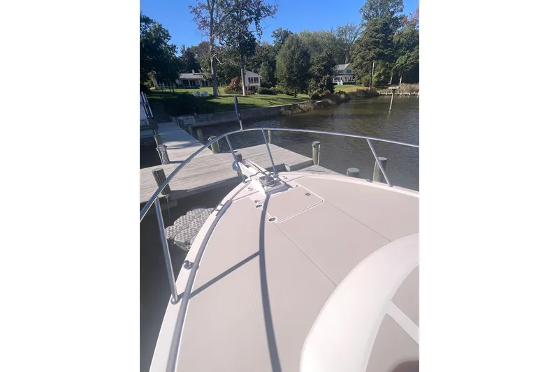 Selah Yacht Photos Pics 2012 Back Cove 37 boat docked by a serene lakeside with lush greenery.