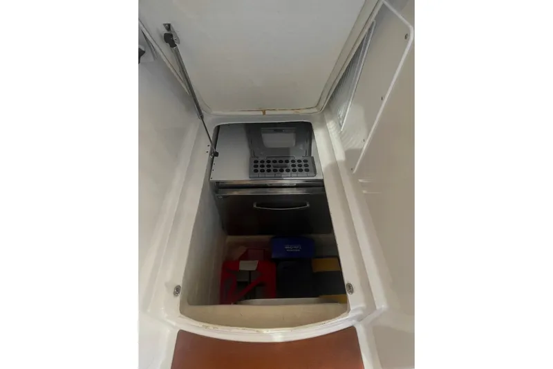 Selah Yacht Photos Pics 2012 Back Cove 37 storage compartment with safety equipment and organized interior.