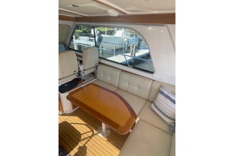 Selah Yacht Photos Pics Interior of 2012 Back Cove 37 yacht with seating and wooden table.