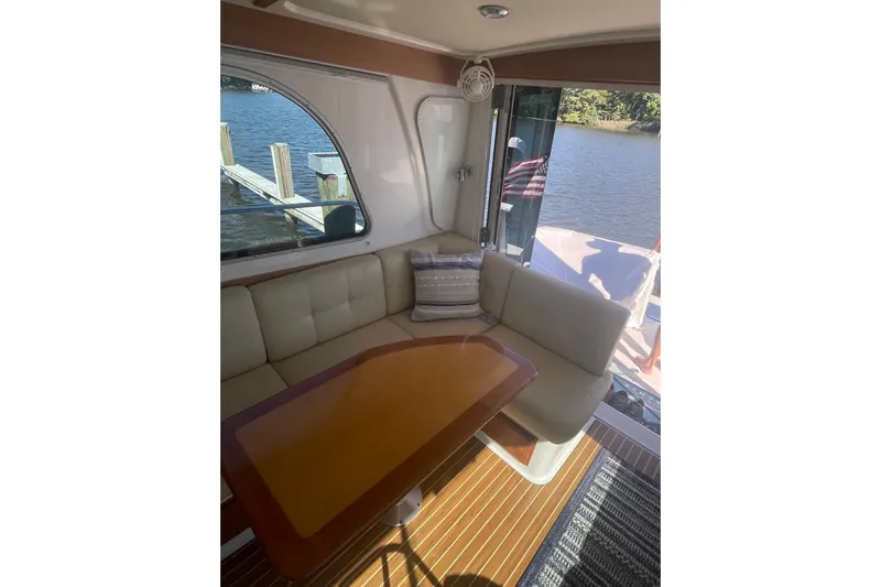Selah Yacht Photos Pics Interior of 2012 Back Cove 37 yacht with cozy seating and table by a window.