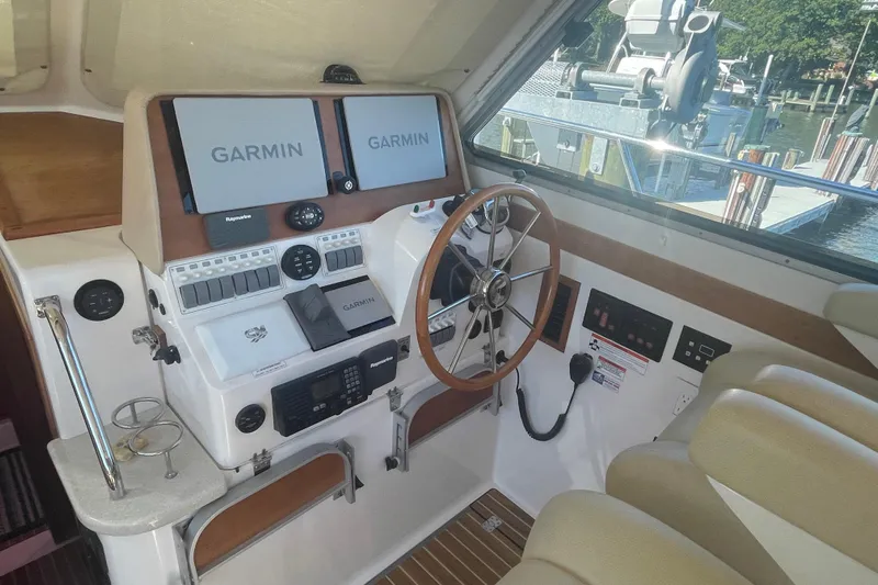 Selah Yacht Photos Pics 2012 Back Cove 37 helm with Garmin navigation, wooden steering wheel, and control panels.