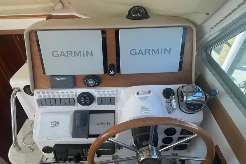 Selah Yacht Photos Pics Helm of 2012 Back Cove 37 with Garmin navigation displays and wooden steering wheel.