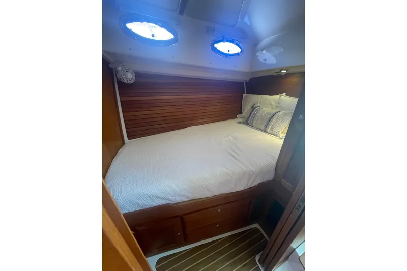 Selah Yacht Photos Pics Cozy cabin interior of 2012 Back Cove 37 yacht with bed and portholes.