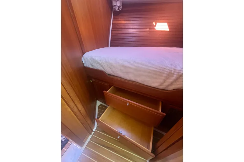 Selah Yacht Photos Pics 2012 Back Cove 37 cabin with wooden interior, bed, and open storage drawers.