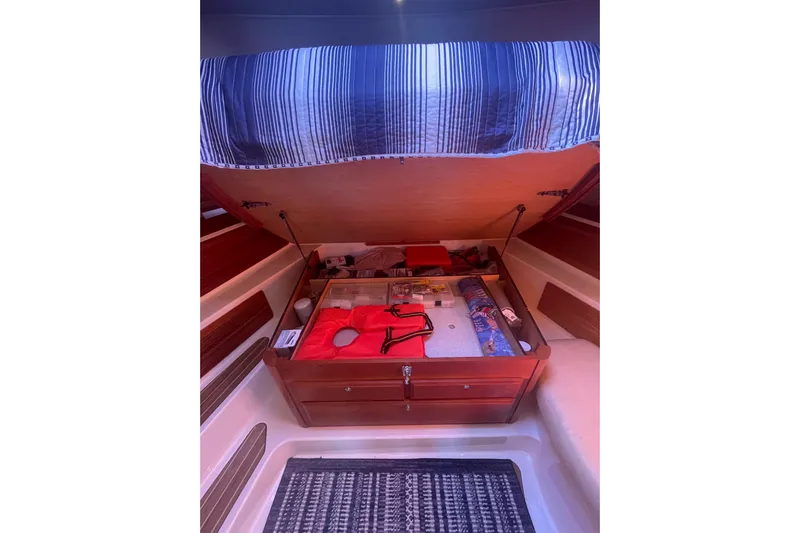 Selah Yacht Photos Pics 2012 Back Cove 37 interior storage compartment with open lid, showcasing organized items.