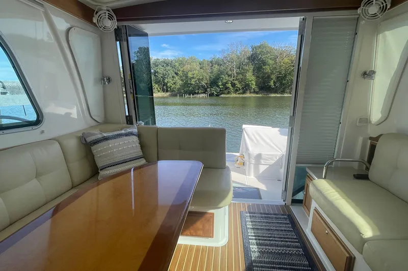 Selah Yacht Photos Pics Interior of 2012 Back Cove 37 yacht with seating, table, and water view.