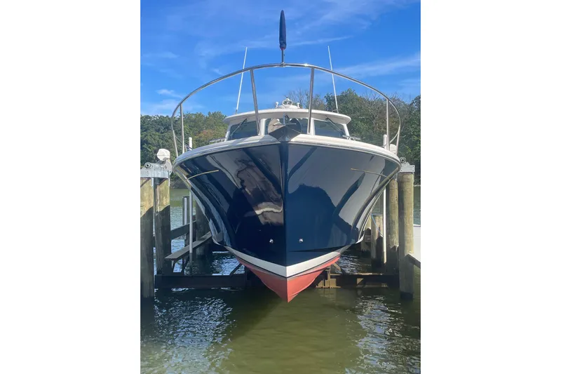 Selah Yacht Photos Pics 2012 Back Cove 37 boat docked, front view, blue hull, clear sky background.