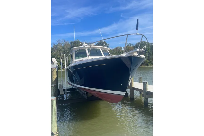 Selah Yacht Photos Pics 2012 Back Cove 37 boat docked on a sunny day, blue hull, white deck.