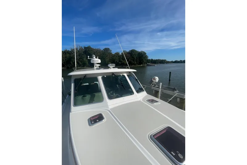 Selah Yacht Photos Pics 2012 Back Cove 37 boat docked by a serene river under a clear blue sky.