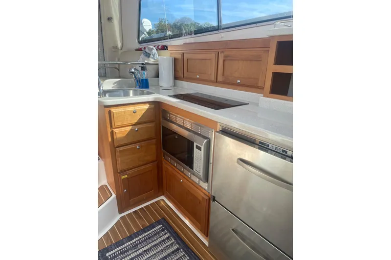 Selah Yacht Photos Pics 2012 Back Cove 37 yacht kitchen with wooden cabinets, stainless appliances, and countertop.