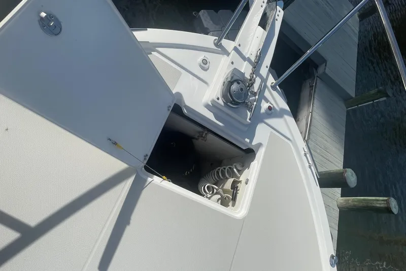 Selah Yacht Photos Pics 2012 Back Cove 37 boat deck with open storage compartment and dock view.