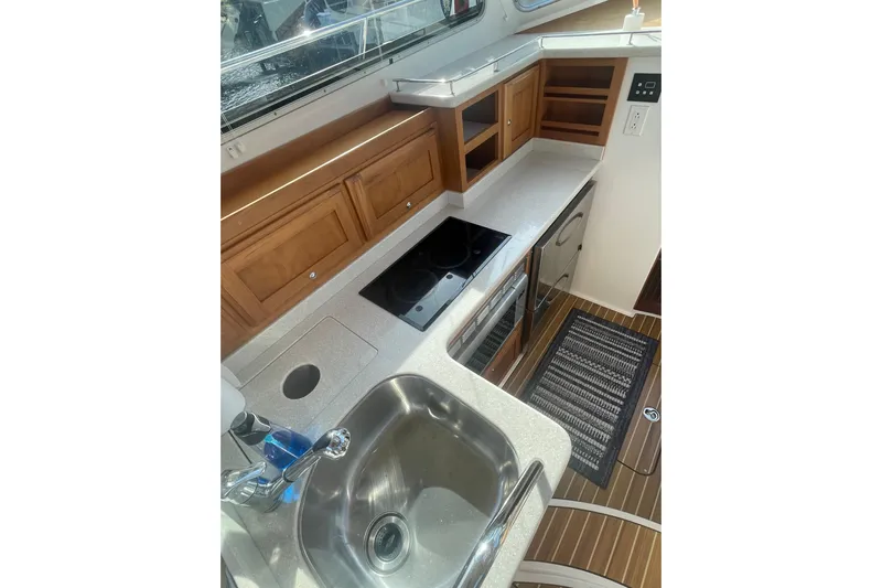 Selah Yacht Photos Pics 2012 Back Cove 37 yacht kitchen with sink, stove, and wooden cabinetry.