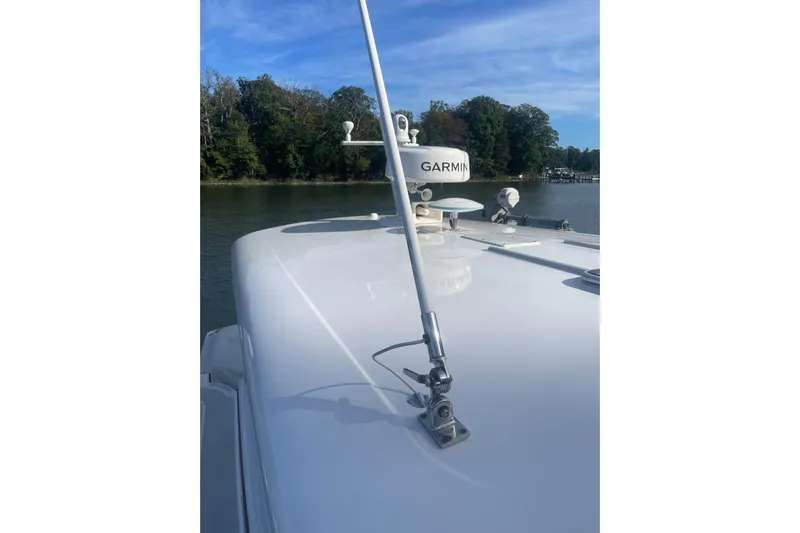 Selah Yacht Photos Pics 2012 Back Cove 37 yacht with Garmin radar, docked near a wooded shoreline.