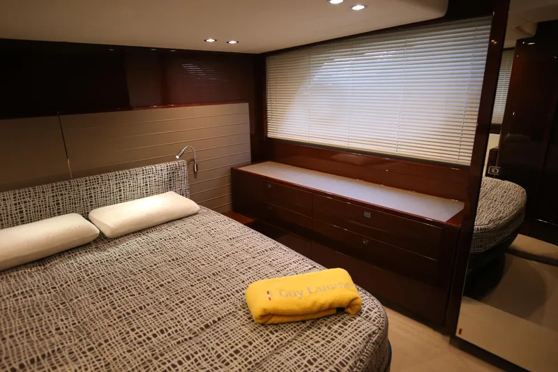 Yacht Photos Pics Luxurious bedroom interior of 2015 Princess V48 yacht with modern decor and cozy bedding.