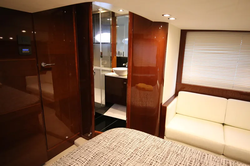  Yacht Photos Pics Luxurious interior of 2015 Princess V48 yacht with modern bathroom and cozy seating area.