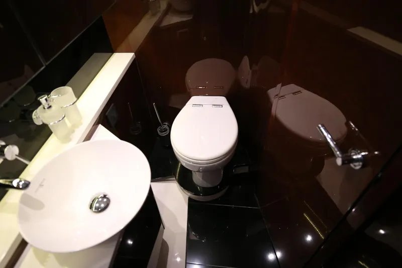  Yacht Photos Pics Luxurious bathroom in 2015 Princess V48 yacht with modern fixtures and sleek design.