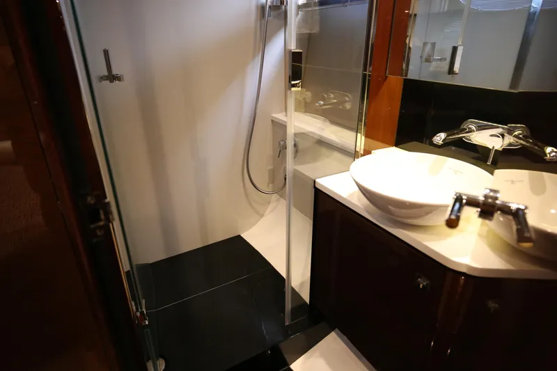  Yacht Photos Pics Luxurious bathroom in 2015 Princess V48 yacht with modern fixtures and glass shower.