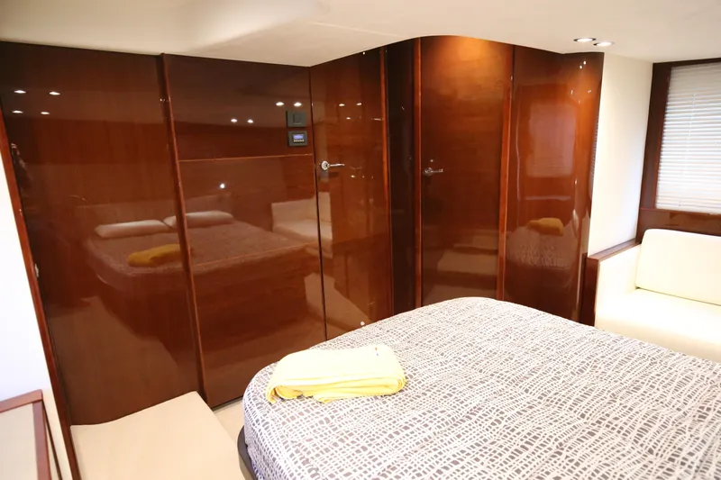  Yacht Photos Pics Luxurious cabin interior of 2015 Princess V48 yacht with polished wood finish.