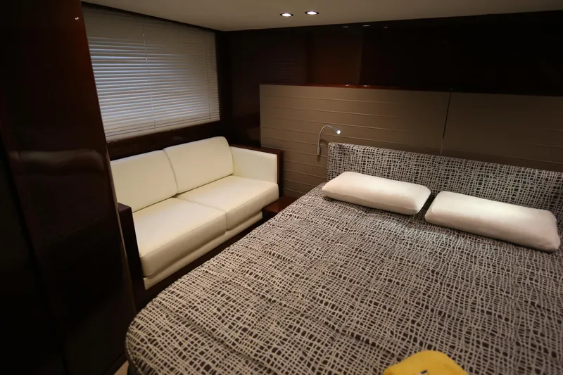  Yacht Photos Pics Luxurious cabin interior of 2015 Princess V48 yacht with bed and sofa.