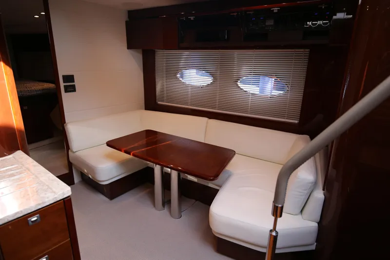  Yacht Photos Pics Luxurious interior of 2015 Princess V48 yacht with elegant seating and wooden table.