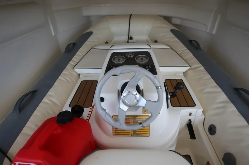  Yacht Photos Pics Interior of a 2015 Princess V48 yacht cockpit with steering wheel and control panel.