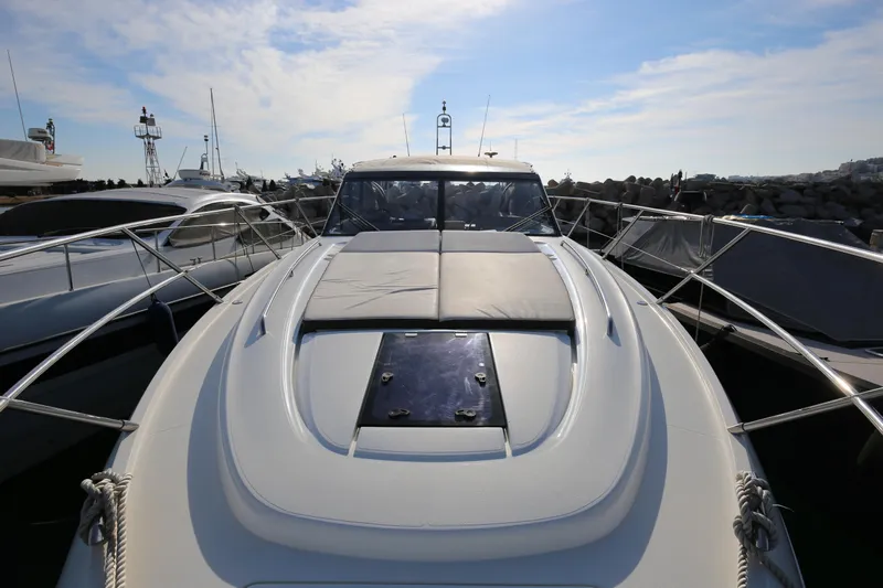  Yacht Photos Pics 2015 Princess V48 yacht docked, showcasing sleek design and spacious deck under a clear sky.