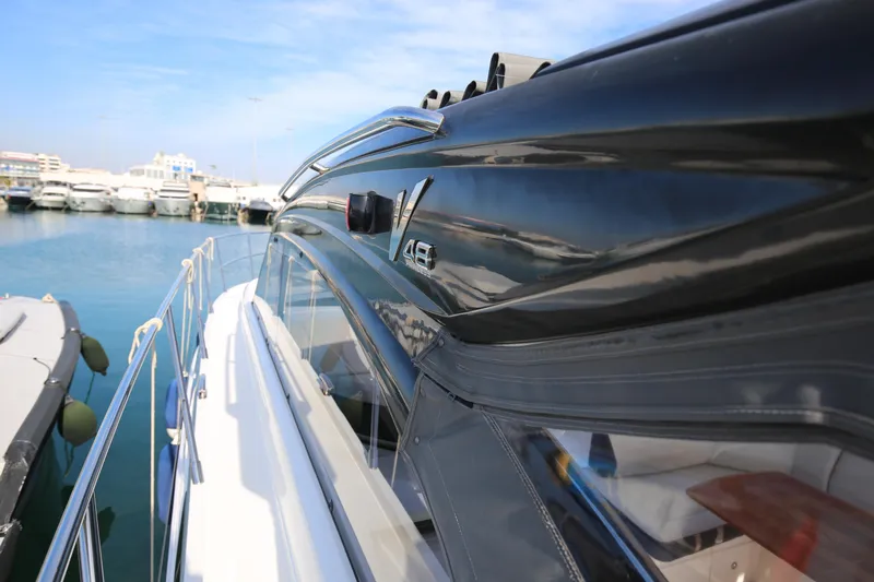  Yacht Photos Pics 2015 Princess V48 yacht docked in marina, sleek black exterior, sunny day.