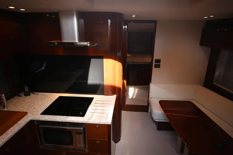  Yacht Photos Pics Luxurious interior of 2015 Princess V48 yacht with modern kitchen and seating area.