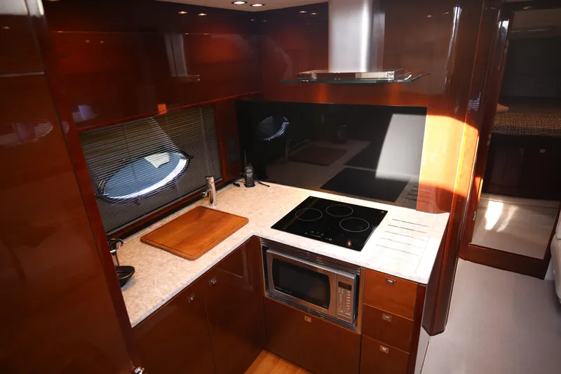  Yacht Photos Pics Luxurious kitchen interior of 2015 Princess V48 yacht with modern appliances.