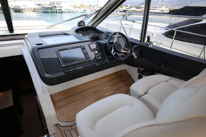  Yacht Photos Pics Helm of 2015 Princess V48 yacht with modern controls and luxurious seating.