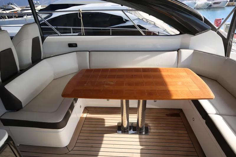  Yacht Photos Pics Luxurious seating area on a 2015 Princess V48 yacht with wooden table.