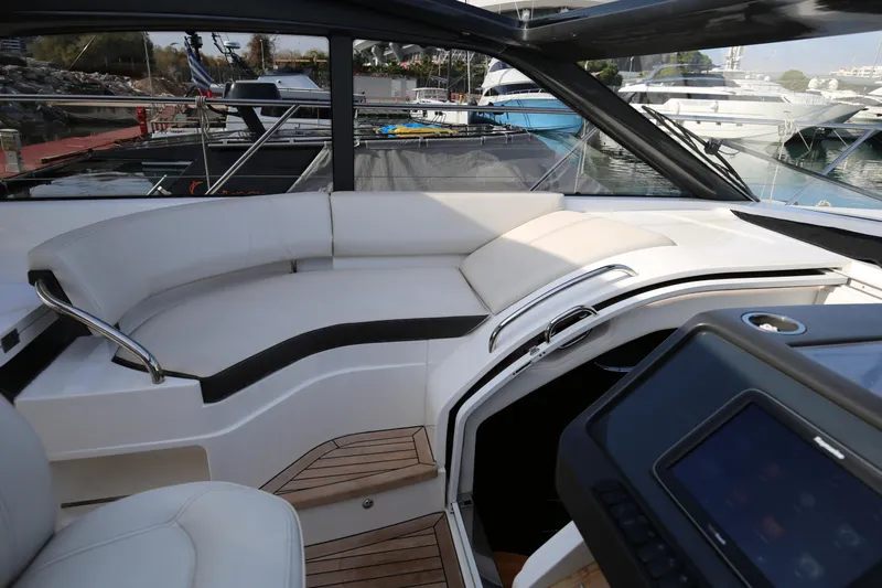  Yacht Photos Pics Luxurious 2015 Princess V48 yacht interior with sleek seating and modern dashboard.