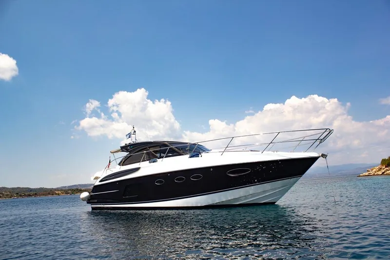  Yacht Photos Pics 2015 Princess V48 yacht on calm water under a clear blue sky.