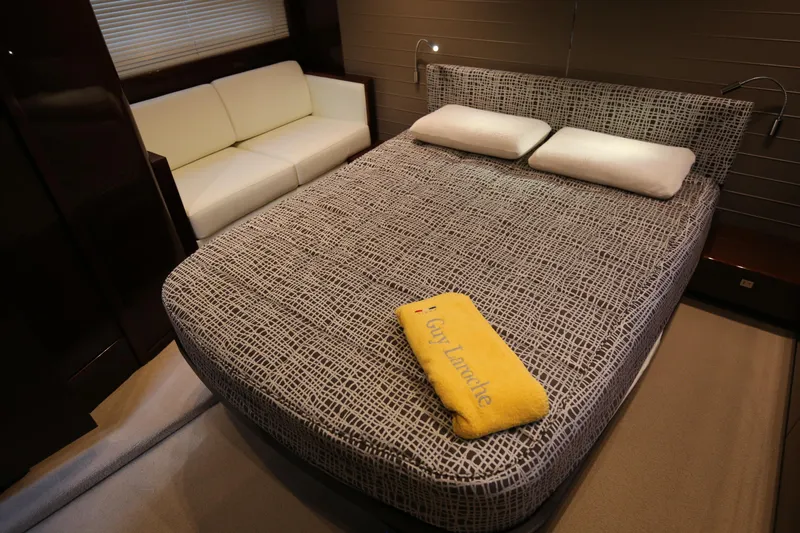  Yacht Photos Pics Luxurious bedroom in 2015 Princess V48 yacht with modern decor and cozy seating.