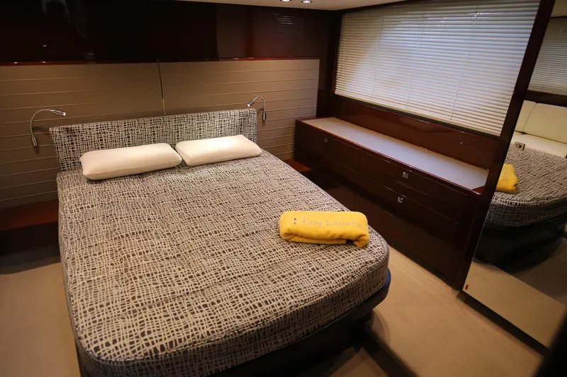  Yacht Photos Pics Luxurious bedroom interior of 2015 Princess V48 yacht with modern decor and comfortable bedding.