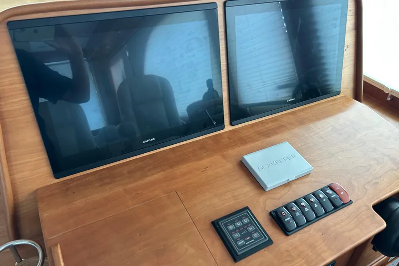  Yacht Photos Pics 2022 Sabre 45 Salon Express dashboard with dual Garmin screens and control panel.