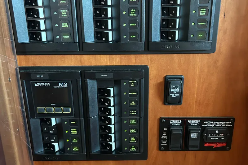  Yacht Photos Pics Control panel of a 2022 Sabre 45 Salon Express yacht with various switches and indicators.