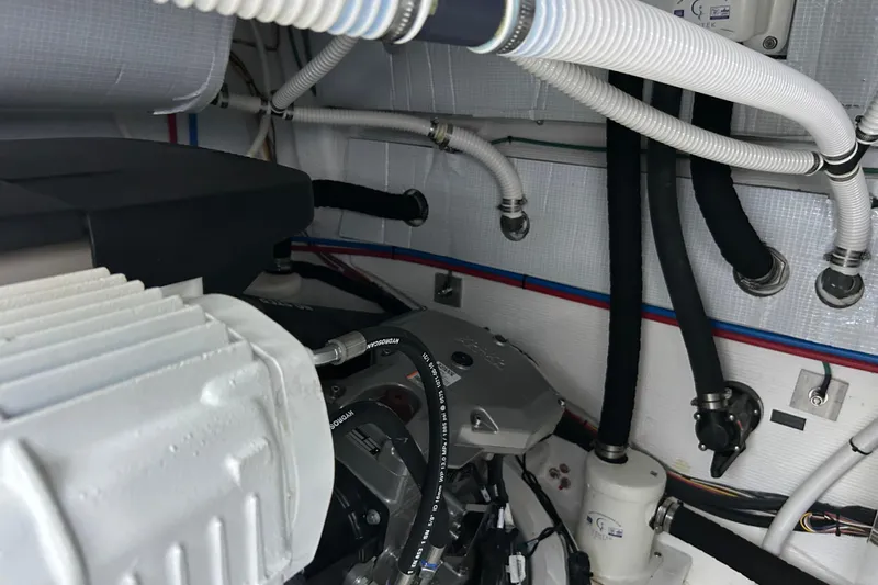  Yacht Photos Pics Engine room of 2022 Sabre 45 Salon Express with visible hoses and components.