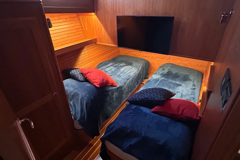  Yacht Photos Pics 2022 Sabre 45 Salon Express cabin with twin beds, cozy lighting, and plush pillows.