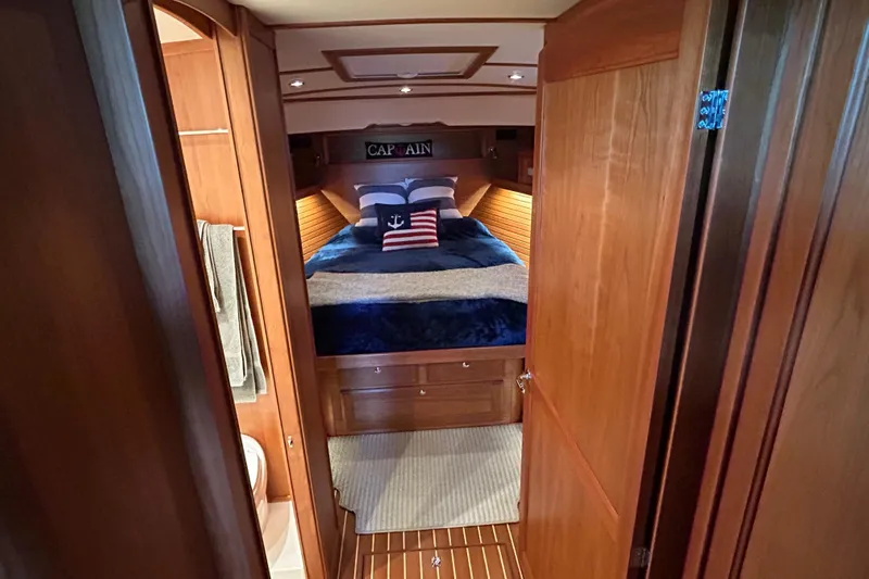  Yacht Photos Pics Interior of 2022 Sabre 45 Salon Express yacht, featuring cozy bedroom with nautical decor.