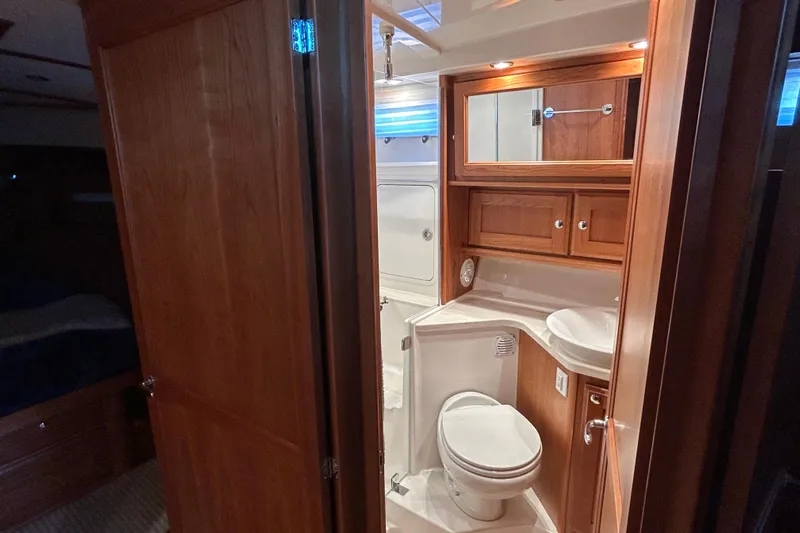  Yacht Photos Pics Luxurious bathroom interior of 2022 Sabre 45 Salon Express yacht, featuring wood cabinetry.