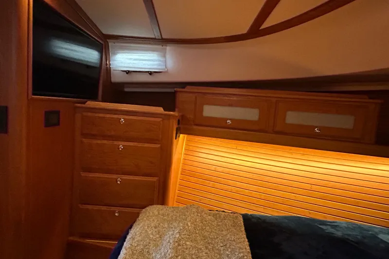  Yacht Photos Pics Luxurious interior of 2022 Sabre 45 Salon Express yacht with wood cabinetry and ambient lighting.