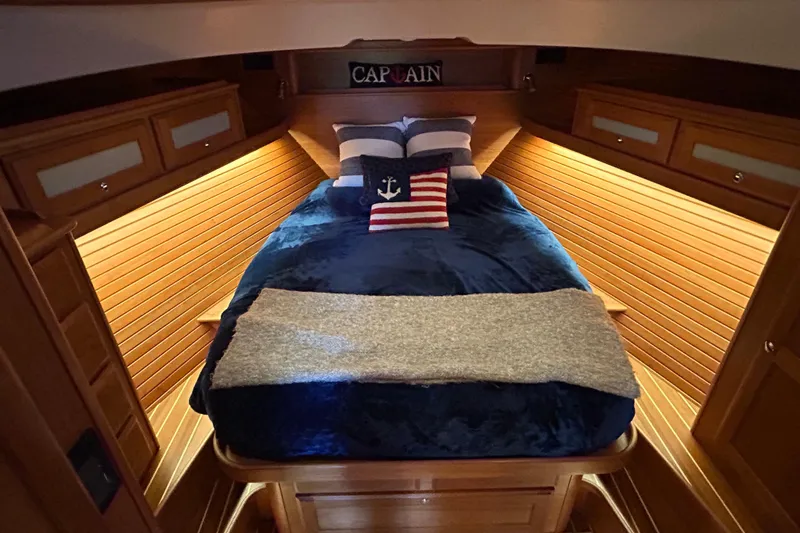  Yacht Photos Pics Luxurious cabin interior of 2022 Sabre 45 Salon Express yacht with cozy bedding.
