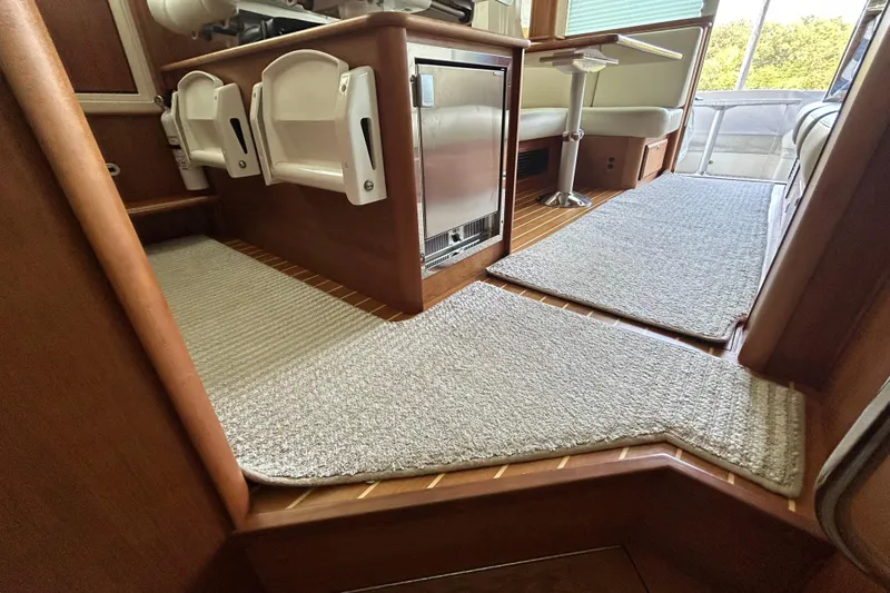 Yacht Photos Pics Interior of 2022 Sabre 45 Salon Express yacht with carpeted flooring and seating area.